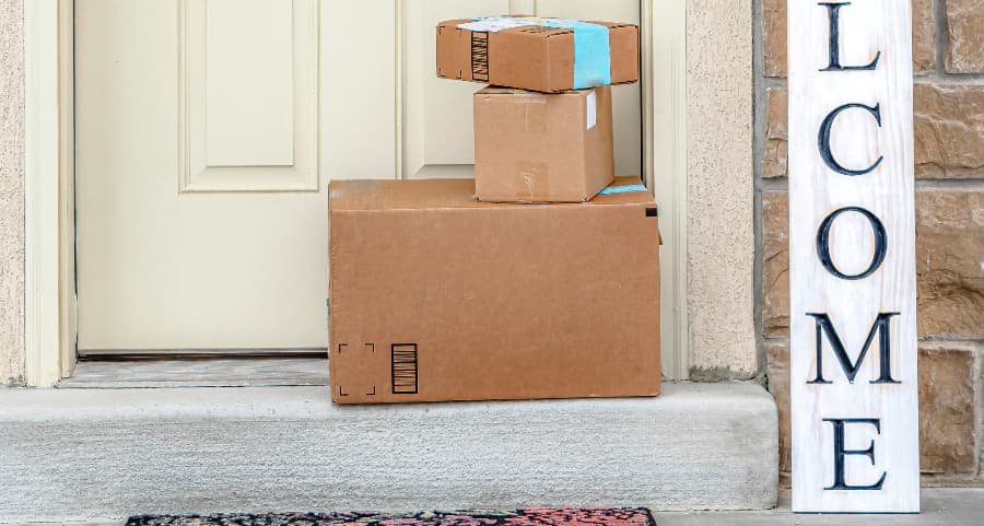 Deliveries on the front porch of a house with a welcome sign in Joplin